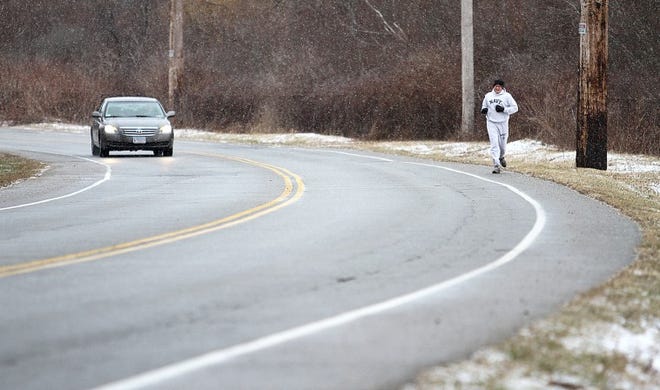 A jogger makes his way down Burma Road in Middletown Tuesday. The road is being considered for a Shoreline Bike Path.