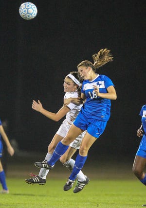 Bartram's Courtney Schell shares a header with Ponte Vedra's Brooke Sharp (L) during the first half of high school girls' soccer action at Ponte Vedra High School on Thursday, December 6, 2012. By GARY MCCULLOUGH, Special to The Record
