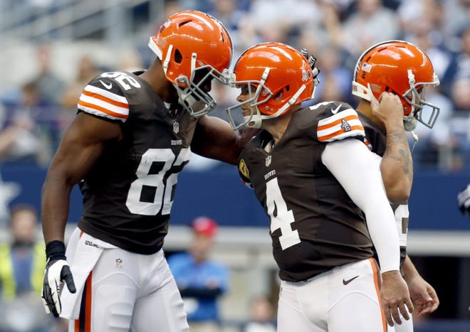 Cleveland Browns' Benjamin Watson (82) taps kicker Phil Dawson (4) on his helmet with his own after Dawson's successful field goal against the Dallas Cowboys in the first half of a game Nov. 18 in Arlington, Texas. (AP Photo/Sharon Ellman)