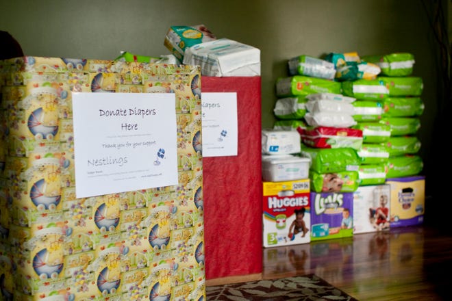 Donation boxes finished and ready to be taken to locations for diaper drives wait in the home of Tania Snyder, one of the three women who have started Nestlings.