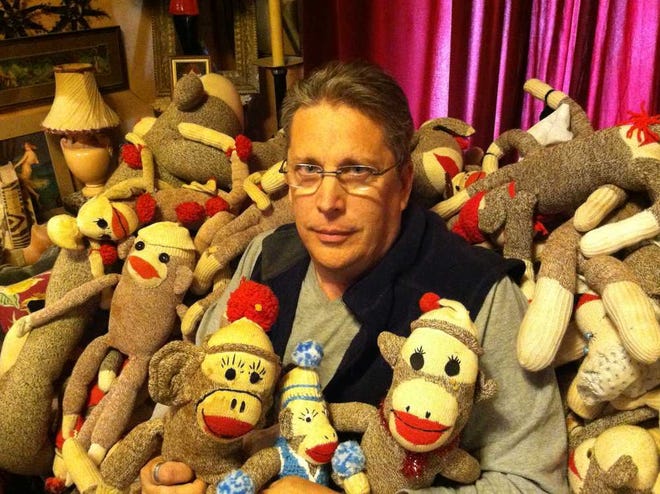 Randy Walker, owner of the Museum of the Odd in Lawrence, is surrounded by some of the sock monkeys he has collected over the years. The museum, which is open by appointment only, is packed with odd and rare items, such as Elvis' underwear, pop-bottle cap men and cow hairballs.