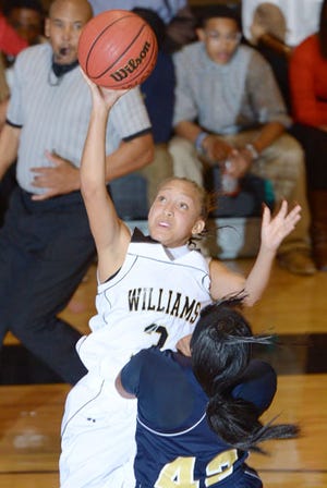 Williams' TaMara Harvey draws a foul from Cummings' Aaliyah Cobb during Friday night's girls' basketball game.