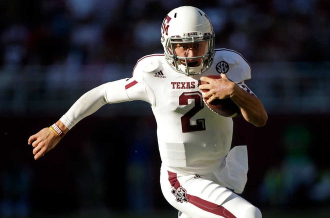 In this Nov. 10, 2012, file photo, Texas A&M quarterback Johnny Manziel (2) runs for a first down during the first half of an NCAA college football game against Alabama.