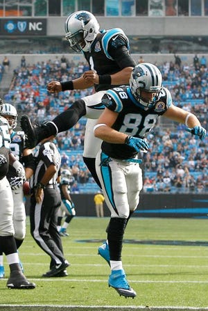 Cam Newton (1) and Greg Olsen (88) celebrate after Newton's touchdown pass to Olsen in Sunday's win.