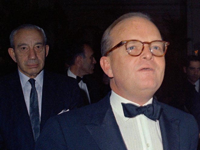 Writer Truman Capote, right, at his famous Black and White Ball at the Plaza Hotel in New York, on Nov. 28, 1966. (AP Photo)