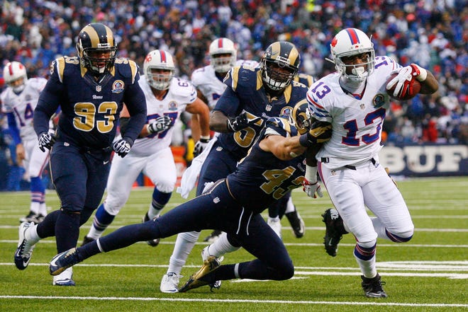 Buffalo Bills wide receiver Stevie Johnson (13) runs with the ball as St. Louis Rams strong safety Craig Dahl (43) tackles him during the second half of Sunday's game in Orchard Park. (AP Photo/Bill Wippert)