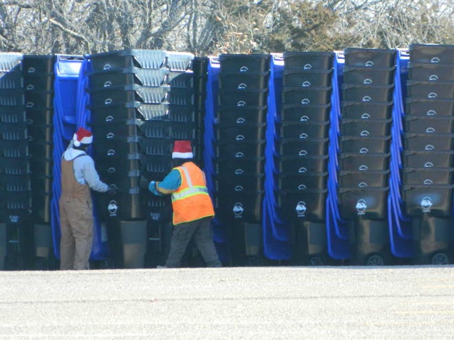Shawnee County workers unload hundreds of bins Monday in the parking lot of the Lake Shawnee Golf Club, 4141 S.E. East Edge Rd.
