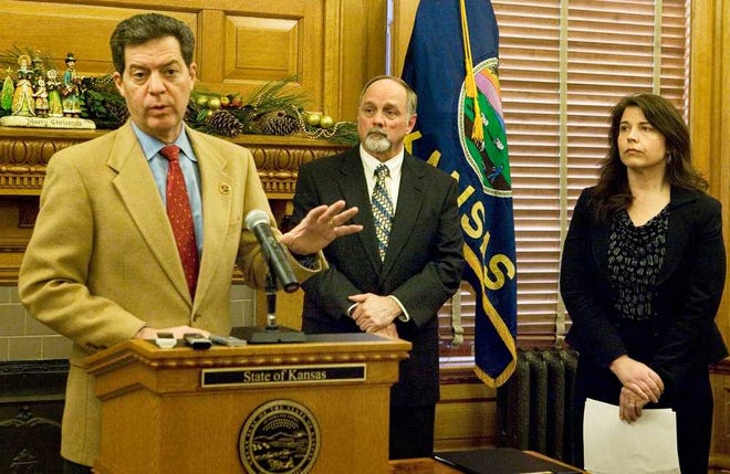 Kansas Gov. Sam Brownback announces Monday afternoon that he will propose an executive reorganization order during the 2013 Kansas Legislative session to merge the Kansas Juvenile Justice authority with the Kansas Department of Corrections. KDOC secretary Ray Roberts, center, and acting JJA commissioner Terri Williams also attended.