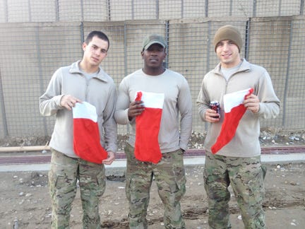 Marcus Slattery, left — a 2010 Greece Olympia graduate who grew up in Greece — celebrates the holidays with fellow U.S. Army soldiers in Afghanistan.