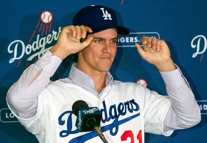 New Los Angeles Dodgers pitcher Zack Greinke adjusts his cap during a news conference announcing his $147 million, six-year contract.