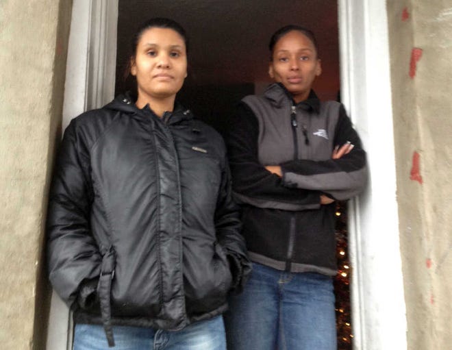 Alicia Barboza, left, and her sister, Shelly Simpson, heard the shots in their Beacon Street neighborhood yesterday afternoon.