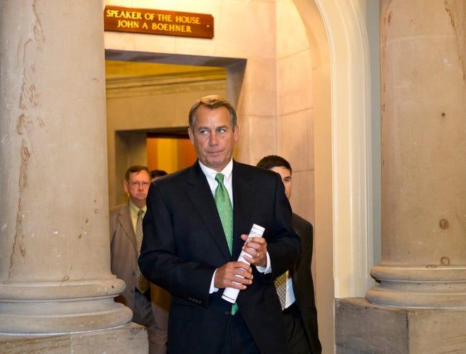 FILE - In this Tuesday, Dec. 11, 2012, file photo, House Speaker John Boehner of Ohio leaves his office and walks to the House floor to deliver remarks about negotiations with President Obama on the fiscal cliff, on Capitol Hill in Washington. Even if Congress and the White House fail to strike a budget deal by New Year's Day, reality may be a lot less bleak then the scenario that's been spooking employers and investors and slowing the U.S. Economy. The tax increases and spending cuts could be retroactively repealed after Jan. (AP Photo/J. Scott Applewhite)