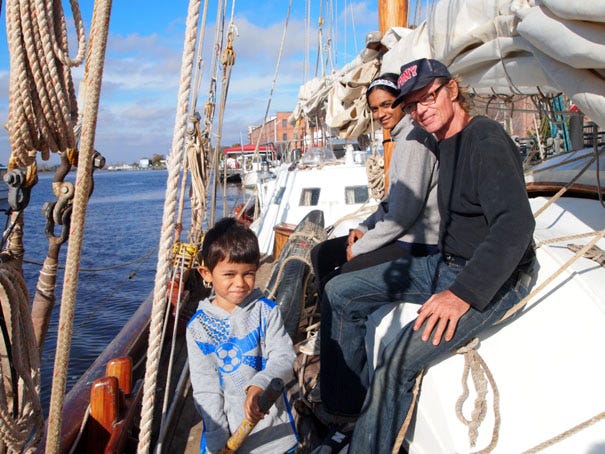 Record-breaking sailor Reid Stowe sits aboard his schooner Anne with his girlfriend, Soanya Ahmad, and the couple's son, Darshen.