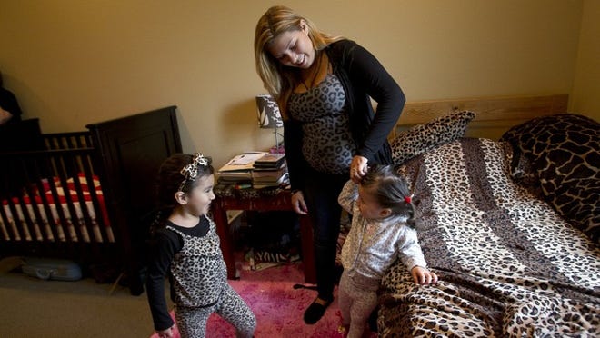 Analicia Rodriguez and her daughters, Anastashia, 3, and Aleina, 2, share a room at the Austin Children’s Shelter. She needs help affording an apartment so she can move out.