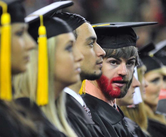 A graduating student sports a half-red beard during the UGA Fall Semester Commencement Ceremony at Stegeman Coliseum on Friday, Dec. 14, 2012, in Athens, Ga. Richard Hamm/Staff