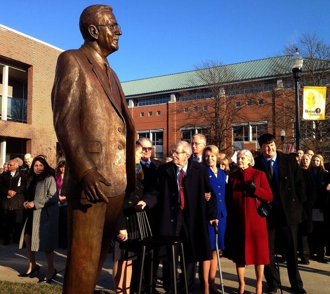 Prominent South Jersey industrialist Henry Rowan (with cane) stands near the statue of himself that was unveiled at Rowan University on Thursday afternoon. His daughter, Virginia Smith, holds his arm.