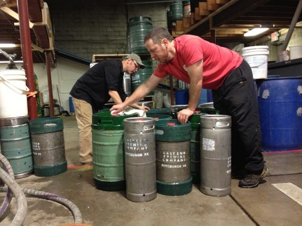 Scott Smith, left, owner of East End Brewing, and Brendan Benson, East End's head brewer, mark just-cleaned kegs to be filled