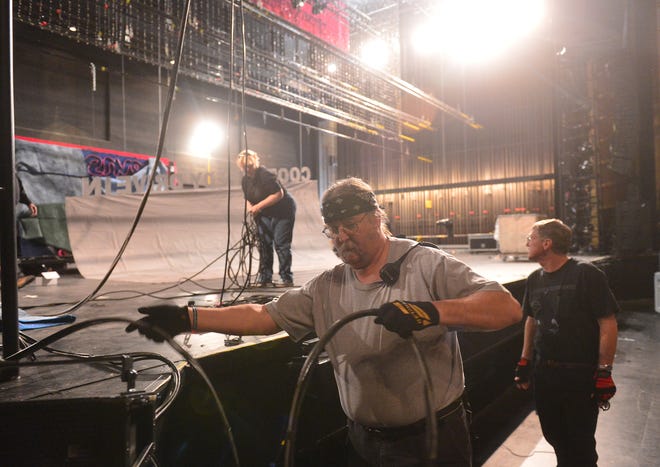 Larry Estes, a union stage employee from Danvers, unwinds audio cable as crews "tech" "Priscilla: Queen of the Desert" at the Peoria Civic Center Friday. The crew, which includes local workers, will spend a few weeks building the set on location for the first time, configuring it for the national tour, which kicks off in January. There will be a preview show in Peoria Jan. 3-4, before the official tour runs in bigger cities like Los Angeles, Philadelphia, and Chicago. "Priscilla" is about a group of drag queens that contract to perform a show in the Australian desert. The show had its Bette-Midler produced Broadway debut in 2011.