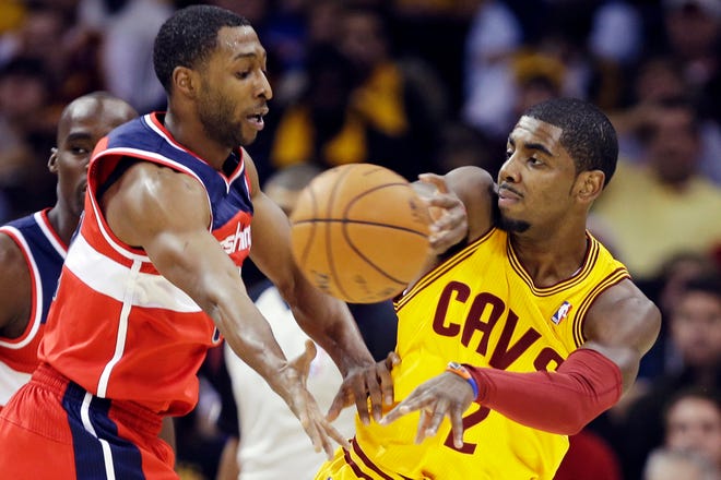 Cleveland Cavaliers' Kyrie Irving (2) passes away from Washington Wizards' A.J. Price in the first quarter of an NBA basketball game, Tuesday, Oct. 30, 2012, in Cleveland.