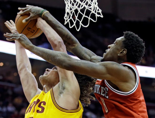 Milwaukee Bucks' Larry Sanders, right, blocks a shot by Cleveland Cavaliers' Anderson Varejao in the fourth quarter of an NBA basketball game on Friday in Cleveland. The Bucks won 90-86.