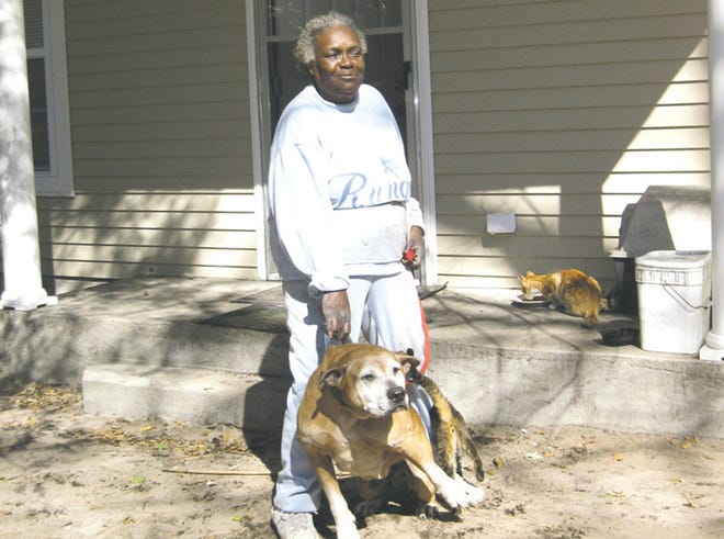Cynthia Green and her dog at 191 Ninth St. in Apalachicola in January 2010.