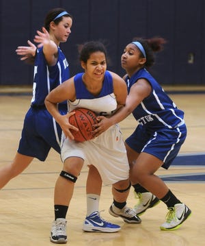 Shelby Dolan, left, and Amirah Terry, right, of Northern Burlington County Regional High School defend against Cassandra Taylor, center, with the Burlington County Institute of Technology in Westampton.
