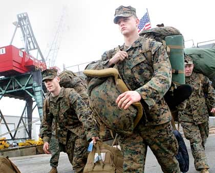 Lance Cpl. Alexander Krieger leads the way as Marines with the 24th Marine Expeditionary Unit from the USS Gunston Hall arrive at the Morehead City Port in Morehead City Sunday afternoon. The 24th MEU served as an expeditionary crisis response force for nearly nine months throughout the U.S. European, Central and Africa Command areas of operation, according to information from the Marine Corps.