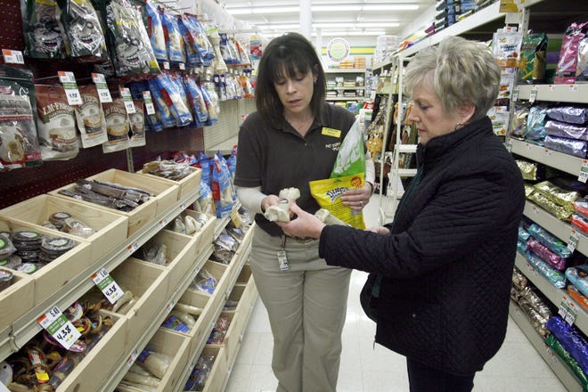 Annette Cachat of Plain Twp, right, gets help from Pet Supplies Plus manager, Melissa Lee, purchasing doggie treats as a Christmas gift.