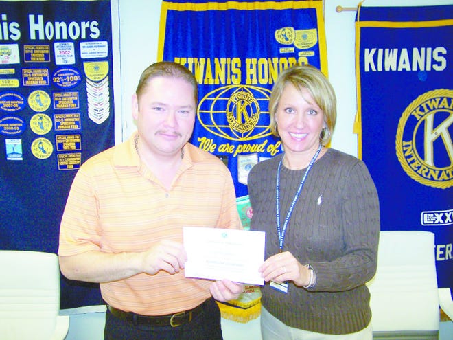 Above, Richards accepts a certificate of appreciation from Kiwanis Club President Amy Galliers. Courtesy photo