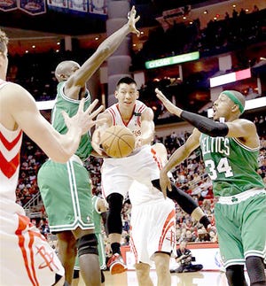 Houston Rocket Jeremy Lin (center) looks to pass the ball as Boston Celtics Paul Pierce (34) and Kevin Garnett defend Friday.