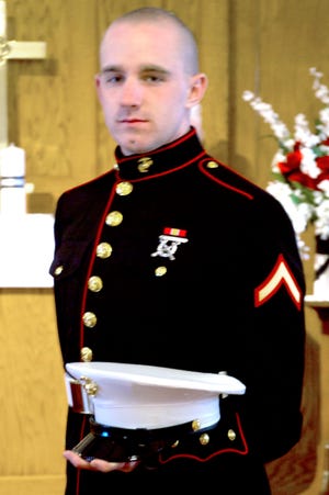 Marine Lance Cpl. Christopher Belk pauses at at a Mapleton church on his wedding day last April. NBC Nightly News is hoping to reunite Belk and his Pekin family with a group of singing strangers who offered them comfort at the Peoria airport Sept. 3. That night, Belk flew out of town, destined eventually for Afghanistan.