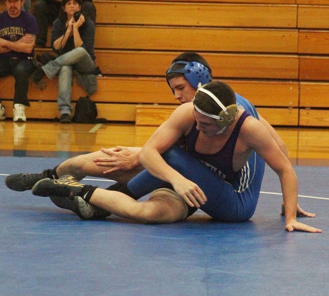 Ionia's Jordan Zamarron wrestles in the 140-pound match Wednesday night during the Bulldogs' contest against Fowlerville.