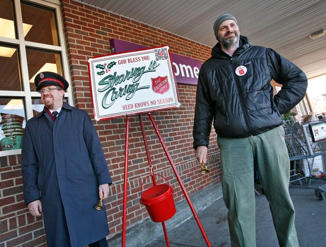 Patriot Ledger reporter Christopher Burrell stands with Lt. Tim Ross, who heads up the Salvation Army's Quincy Corps, outside Stop & Shop on the Southern Artery in Quincy. Burrell tried his hand as a bell-ringer for two hours Friday, Dec. 14, 2012.