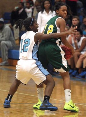 Crest’s A'Diyah Ussery struggles to move the ball through Burns’ Rekyla Briscoe during their game at Burns High School on Dec. 7.