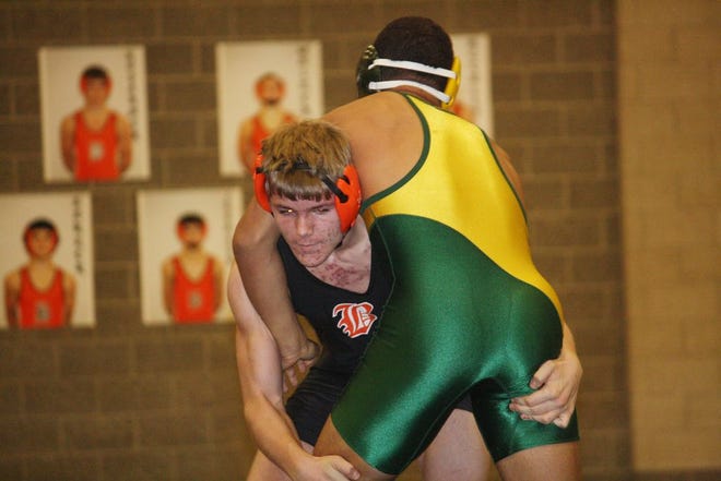 Blake Rodarmer of Belding looks to make a move on Comstock Park's Aaron Martin at 171 pounds.
