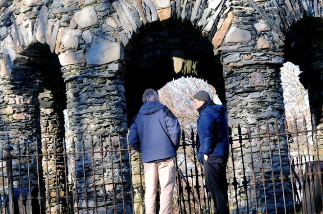 Forensic geologist Scott Wolter and Jim Egan of the Newport Tower Museum on Mill Street, debate conflicting theories on the origin of the historic structure as a beam of light passes through the south window onto the keystone above the west arch during filming for an episode of America Unearthed to air on the H2 Channel in March, Thursday in Newport