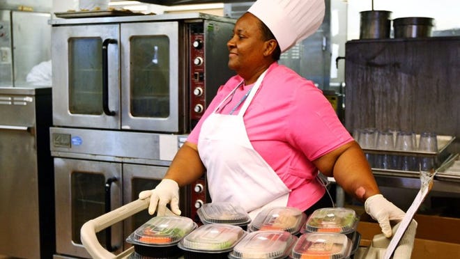 Prep cook Ruby McLean prepares meals for delivery volunteers at the Jupiter Medical Center Pavilion recently. The community feeding program has been delivering meals to homebound residents in northern Palm Beach County for 30 years. (Richard Graulich/The Palm Beach Post)