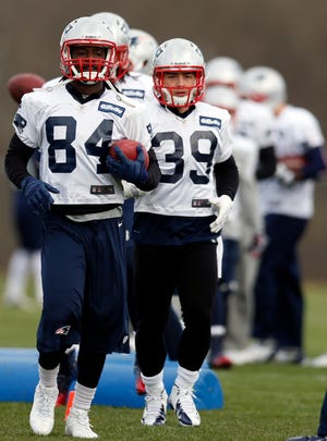 Patriots wide receiver Deion Branch (84) and running back Danny Woodhead (39) run a drill during the team's practice on Wednesday in Foxboro.