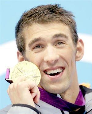 Michael Phelps poses with his gold medal in the men's 4-by-100-meter medley swimming relay at the 2012 Summer Olympics in London.