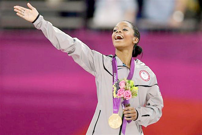 Gabrielle Douglas acknowledges the crowd after receiving her gold medal in the artistic gymnastics individual all-around competition at the 2012 Summer Olympics in London.
