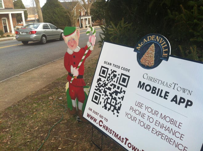 An elf flanks the McAdenville sign that encourages visitors to use a self-guided mobile app tour of the town. This is the first year Pharr Yarns and CC Communications have offered the complement to the Christmas light display. The app should have new features and be available on iTunes and the Android app store by next year. Until then, visitors can go to ChristmasTownTour.com from a smartphone or computer.