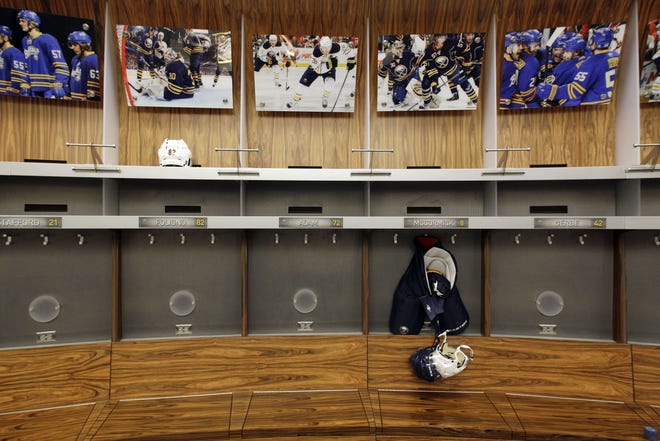 In this Sept. 25, 2012 file photo, an empty locker room is shown during the NHL labor lockout at the First Niagara Center, home of the Buffalo Sabres hockey team, in Buffalo, N.Y. The NHL lockout that's already wiped out the first three months of the season is taking its toll on Buffalo businesses. And it's no different in many of the NHL's 29 other markets. (AP Photo/David Duprey, File)
