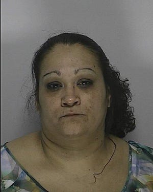 Awilda Alago, charged with assault in an incident in which police said she knocked down a wall.