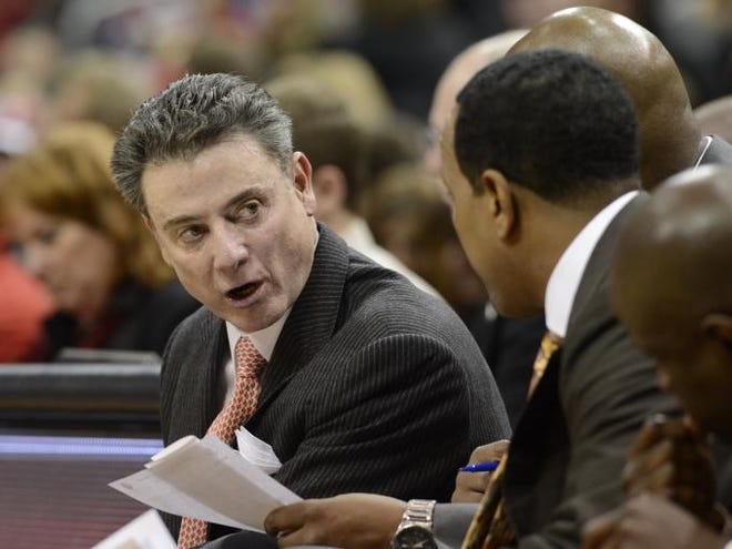 Louisville head coach Rick Pitino talks to his assistants during the first half of an NCAA college basketball game against Samford, Thursday, Nov. 15, 2012, in Louisville, Ky.
