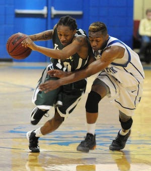 West Brunswick's Oj Hill (10) drives the ball down court under pressure from Whiteville's Carlos Smith (10) in the second half at Whiteville High School Thursday, Dec. 20, 2012.