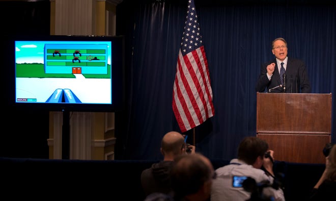NRA's Wayne LaPierre gestures as he speaks about the violent online video game "Kindergarten Killers" during a news conference in response to the Connecticut school shooting.
