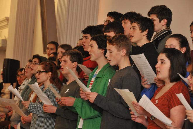 Students from Newton North and South High Schools sing "Amazing Grace" on Wednesday, December 19 at Newton City Hall. This was part of the "Vigil to Remember the Victims of Newtown, Connecticut."