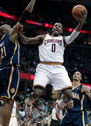Cleveland Cavaliers' C.J. Miles (0) jumps to the basket against Indiana Pacers' David West (21) during the second quarter of an NBA basketball game on Friday, Dec. 21, 2012, in Cleveland.