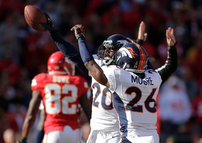 Denver Broncos strong safety Mike Adams (20) celebrates a fumble recovery with free safety Rahim Moore (26) during the first half of an NFL football game against the Kansas City Chiefs at Arrowhead Stadium in Kansas City, Mo., Sunday, Nov. 25, 2012.