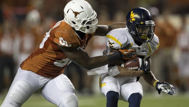 Defensive end Alex Okafor (80) tackles West Virginia running back Andrew Buie in the fourth quarter on Oct. 6, 2012.